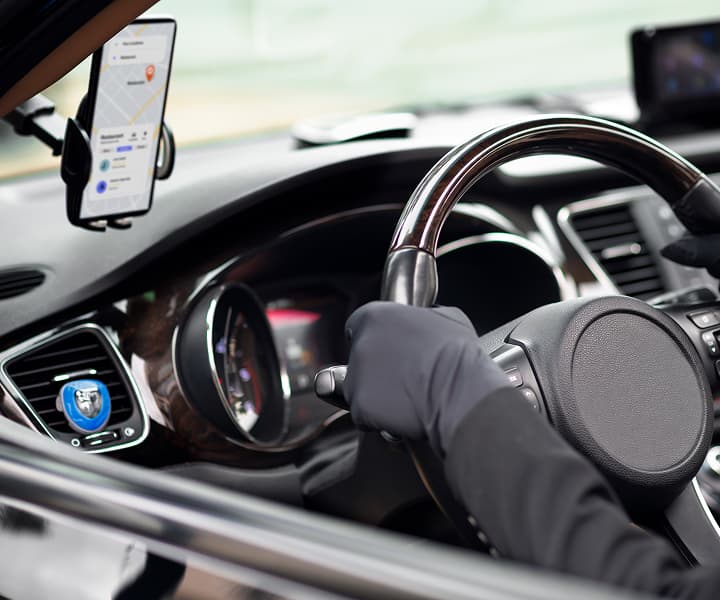 Smartphone with car navigation app mounted on a dashboard