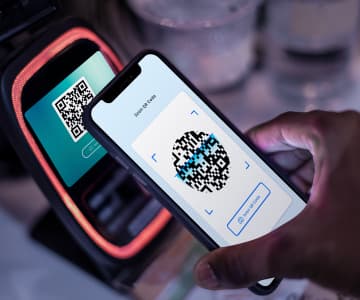 Paying via QR code scan at a contactless payment terminal