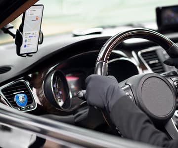 Smartphone with car navigation app mounted on a dashboard